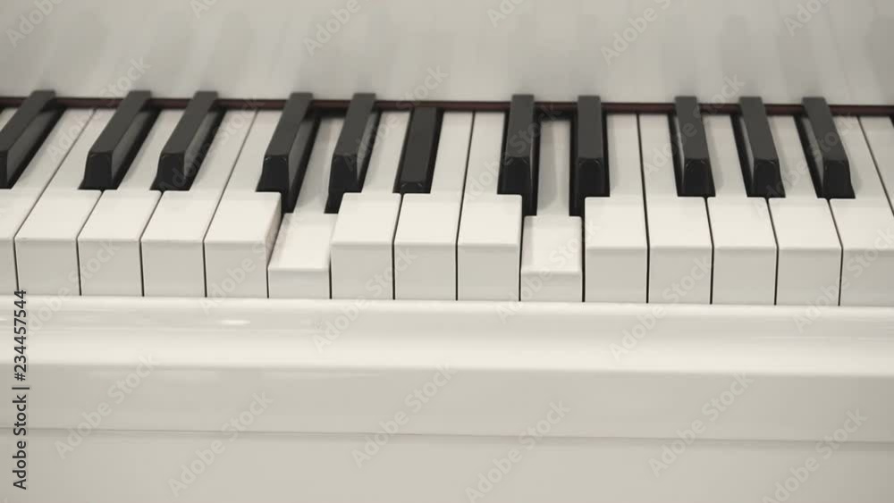 Self-Playing White Piano Without Pianist. Playing Piano Itself. Close Up Front view Self-Playing White Piano Without Pianist. Playing Piano Itself. Close Up Front view