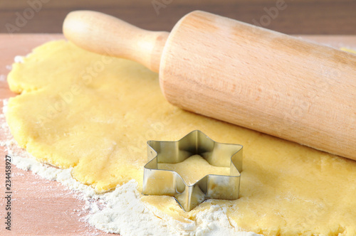 baking christmas star shape cookies. fresh dough. photo