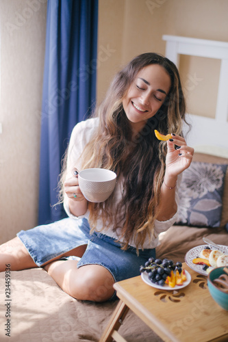 Young beautiful woman enjoying her morning tea at home
