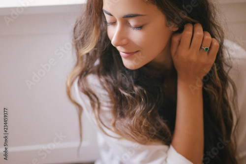 Young beautiful woman enjoying her morning tea at home