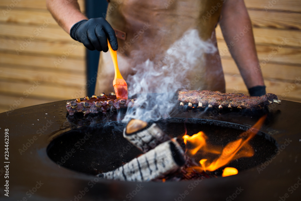 Grilled pork baby ribs with barbecue sauce on the grill. Festival street food Grilled pork baby ribs with barbecue sauce on the grill. Festival street food