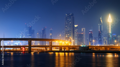 Beautiful view to Dubai downtown city center skyline reflected in water at night, United Arab Emirates © Ivan Kurmyshov