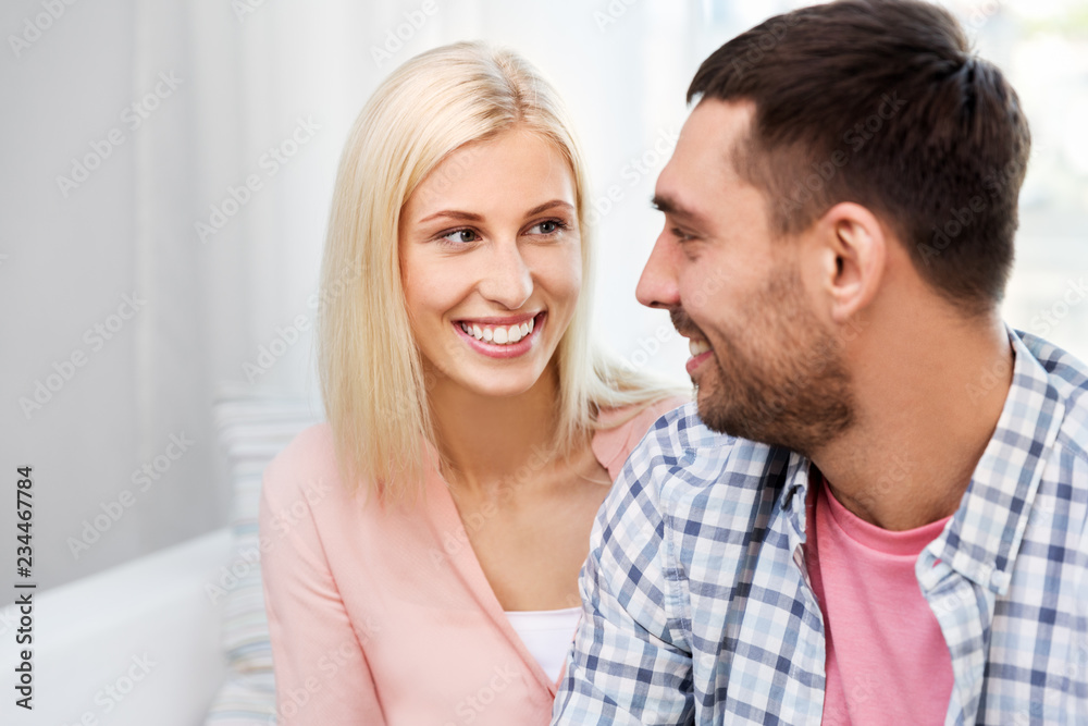 love, relationships and people concept - smiling happy couple looking at each other at home love, relationships and people concept - smiling happy couple looking at each other at home