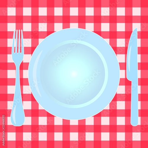 Plate, fork and knife on checkered tablecloth