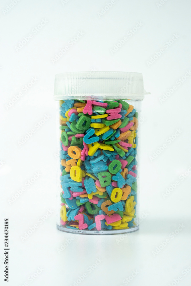 Sprinkle alphabet cake decoration on white background. Sprinkle alphabet cake decoration on white background.
