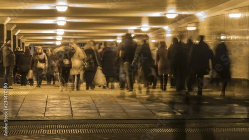 crowds of people moving through the underpass