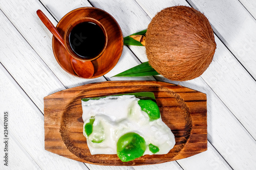 Badak berendam a local Malaysian dessert and cuf of coffee  on wooden background photo