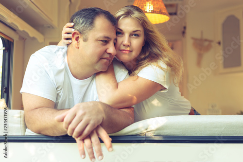 Happy couple of tourists sitting in a camper van.