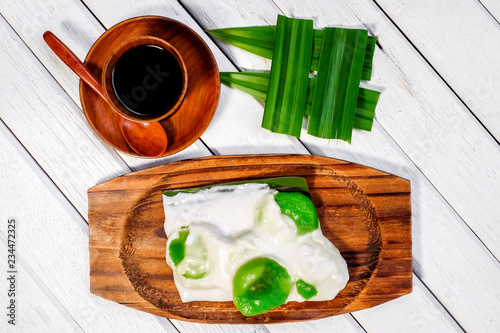 Badak berendam a local Malaysian dessert and cuf of coffee  on wooden background photo