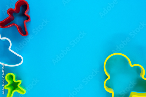 Cookie cutter gingerbread on blue background.