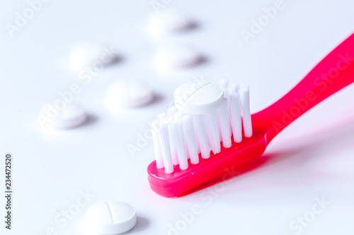 concept toothache with toothbrush and pills at white background