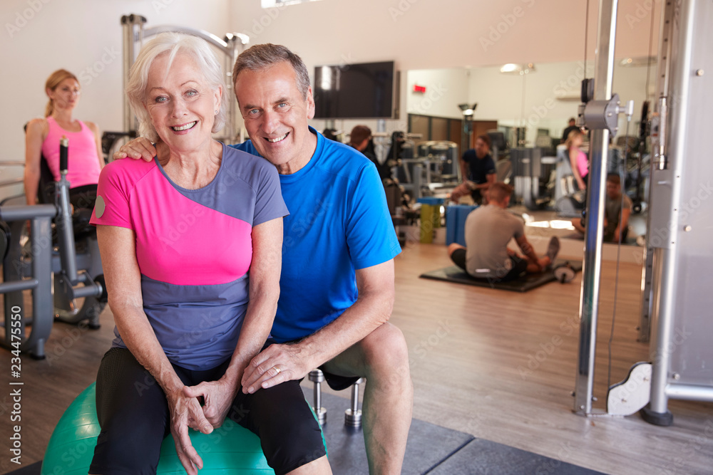 Portrait Of Active Senior Couple Exercising In Gym Together Portrait Of Active Senior Couple Exercising In Gym Together