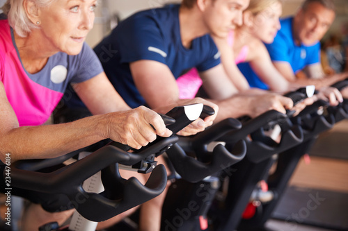 Close Up Of Group Taking Spin Class In Gym