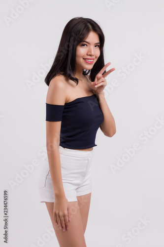 happy smiling woman showing two fingers. positive optimistic winning woman studio white isolated with 2 fingers, v for victory hand sign. young adult beautiful girl asian woman model