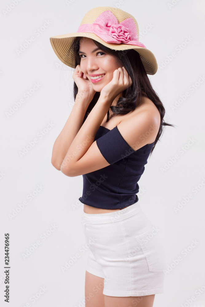 happy smiling woman wearing summer travel hat. portrait of positive optimistic woman traveller, studio white isolated with holiday or vacation concept. young adult beautiful girl asian woman model happy smiling woman wearing summer travel hat. portrait of positive optimistic woman traveller, studio white isolated with holiday or vacation concept. young adult beautiful girl asian woman model