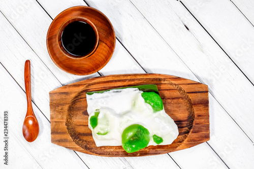 Badak berendam a local Malaysian dessert and cuf of coffee  on wooden background photo