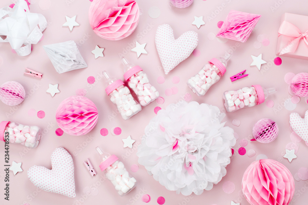 Pink and white Paper Decorations, pom-pom, candy, hearts, gifts, confetti for Baby party. Birthday concept. Flat lay, top view Pink and white Paper Decorations, pom-pom, candy, hearts, gifts, confetti for Baby party. Birthday concept. Flat lay, top view