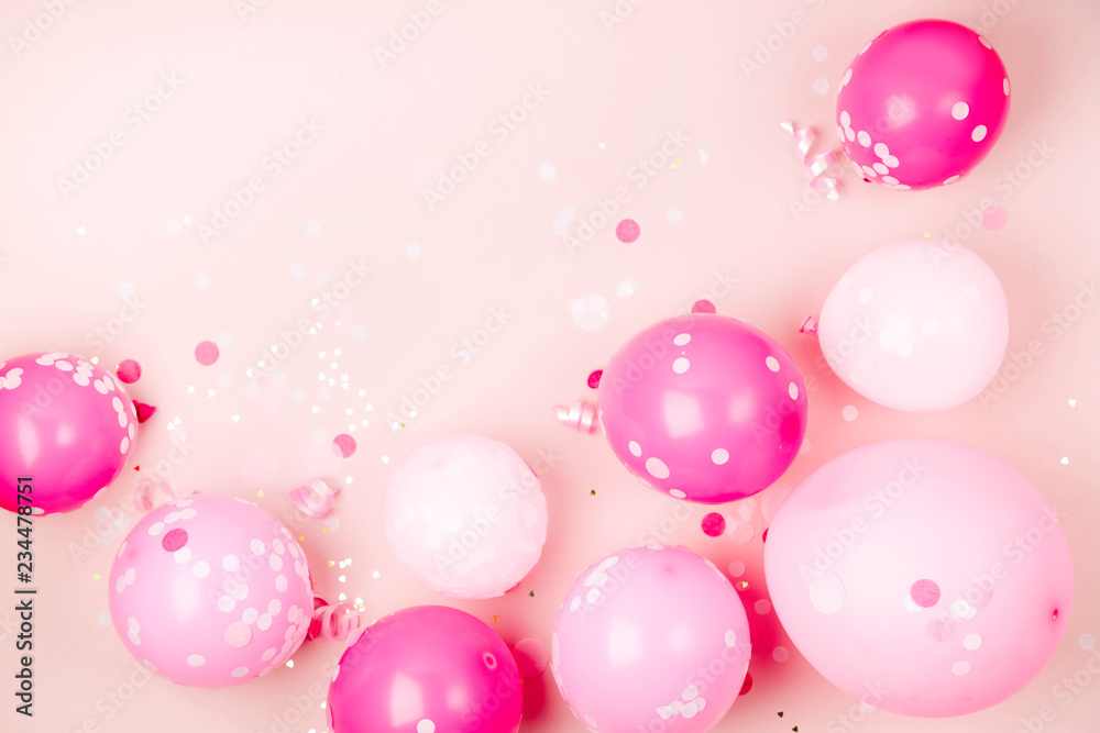 Pink balloons  with Confetti, bows and paper decorations. Birthday party concept theme. Flat lay, top view
