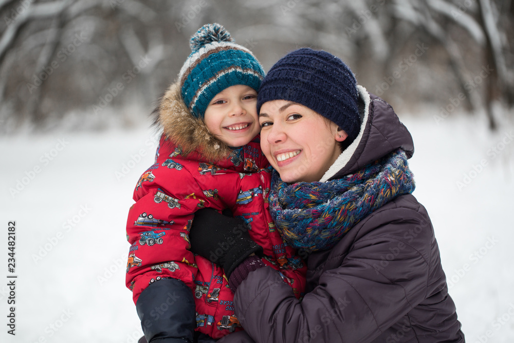 Happy mother and baby in winter park