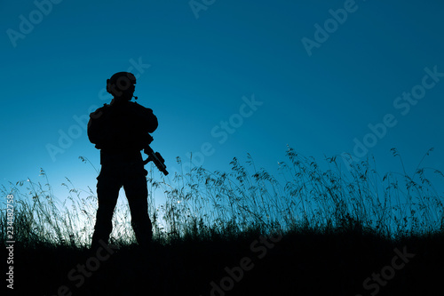 military soldier with weapons at sunset. shot, holding gun, colorful sky. military concept.