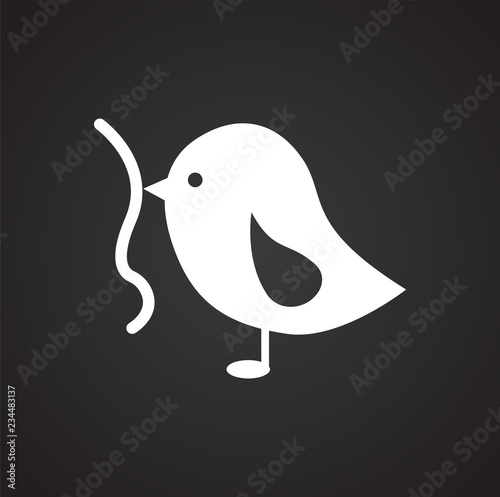 Bird with worm on black background icon