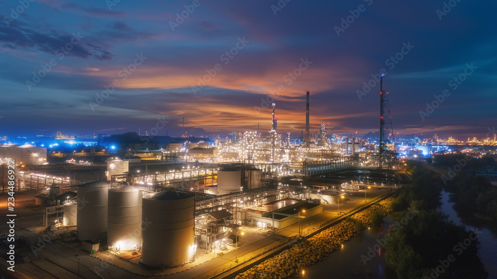 Oil refinery factory at dusk for energy or gas industry or transportation background.