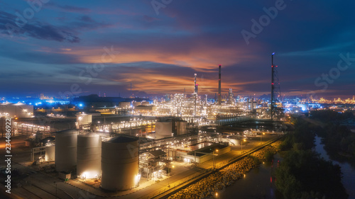Oil refinery factory at dusk for energy or gas industry or transportation background. © Pawinee