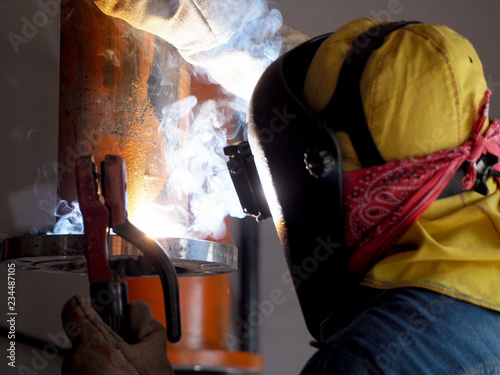 Welding work, worker with protective welding metal on construction