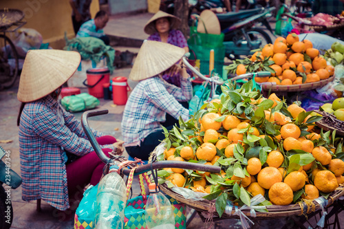 Fresh vegetables and fruits in traditional street market in Hanoi, Vietnam.