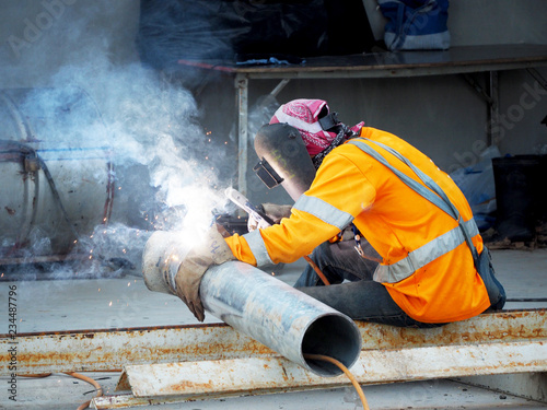 Welding work, worker with protective welding metal on construction