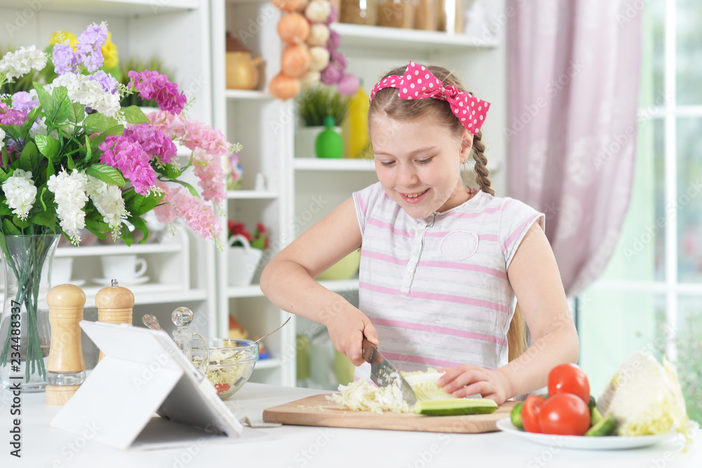 Cute girl preparing delicious fresh salad in kitchen Cute girl preparing delicious fresh salad in kitchen