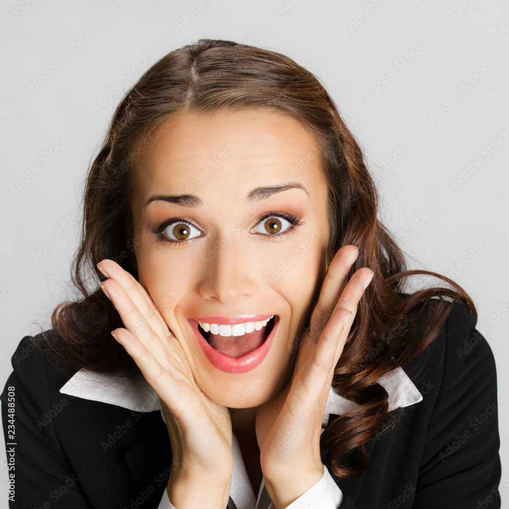Surprised businesswoman, on gray Surprised businesswoman, on gray