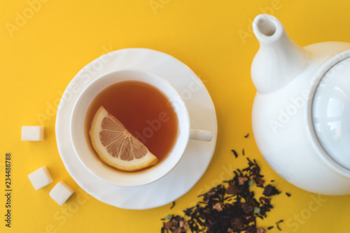 Teapot and cup of tea on a yellow background fletley.