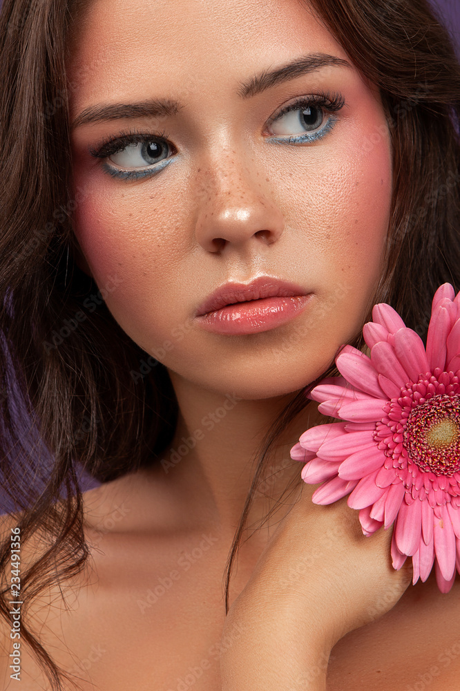 beauty portrait of young female with pink flower with makeup beauty portrait of young female with pink flower with makeup