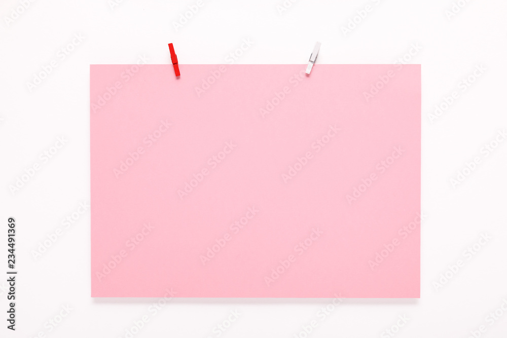 paper card on clothes peg on white background