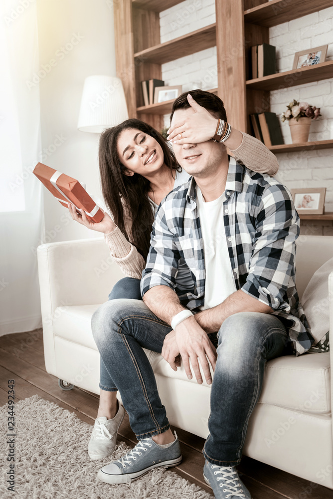 Obraz premium Casual style. Relaxed boy sitting on sofa and waiting for surprise