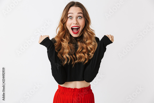 Fotografie Portrait of an excited pretty young woman