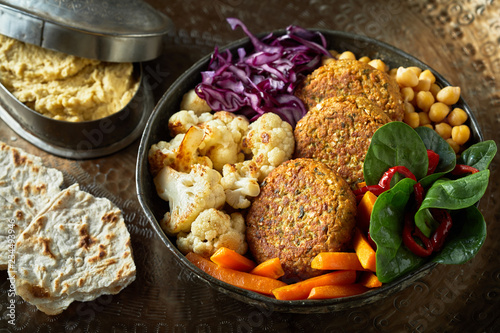 Ceramic bowl of vegetables and cutlets photo