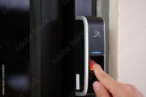 Close up of a man paste finger to biometric fingerprint scanner. Security, Door access control, Validation, cybersecurity and fingerprint password, Future Technology. Business Safety Concept. photo