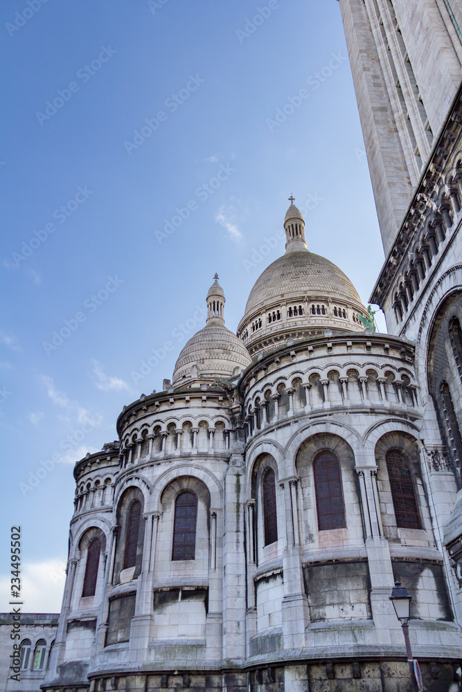 Sacre-Couer on a sunny day under blue skies photographed from a non-traditional angle