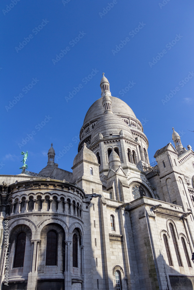 Sacre-Couer on a sunny day under blue skies photographed from a non-traditional angle
