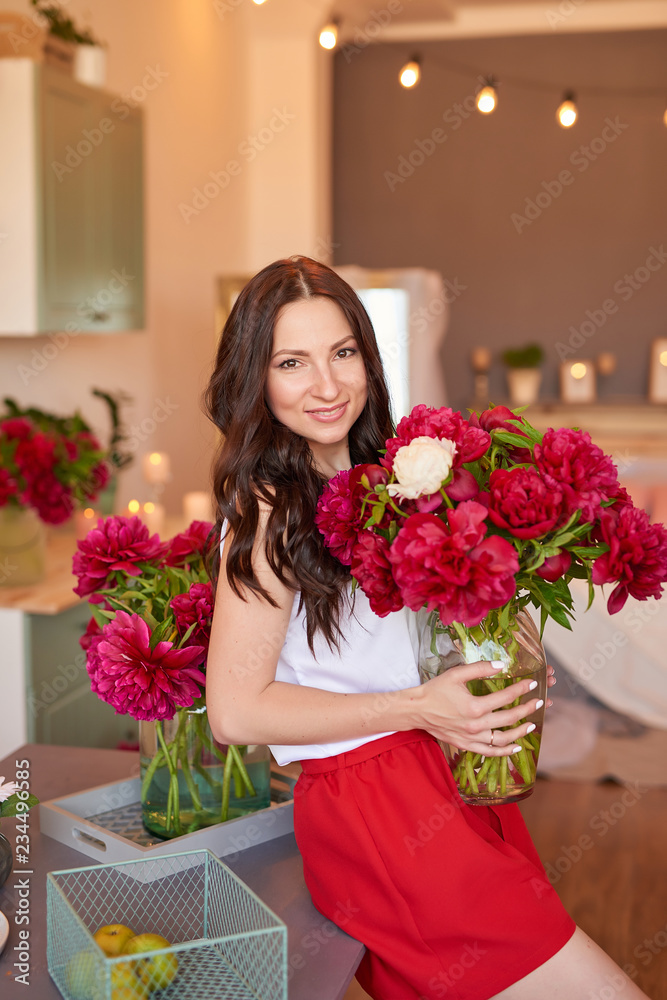 Girl with peonies bouquet. Bouquet of peonies. Flower delivery to workplace. Spring girl with flowers. Bouquet as gift. Emotions of happiness and joy. Valentines day. Mothers day. Fashion Brunette 