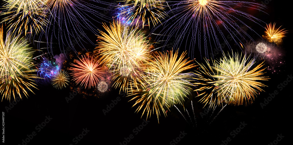 Fireworks colorful explosions on black, festive wide banner background with copy space