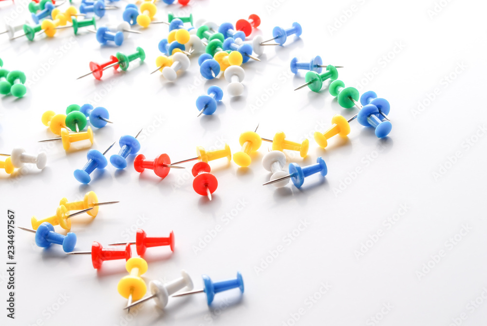 Colorful pushpins on white. Office supplies. Colorful pushpins on white. Office supplies.