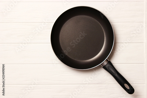 frying pan and on the wooden table top view. Cooking.