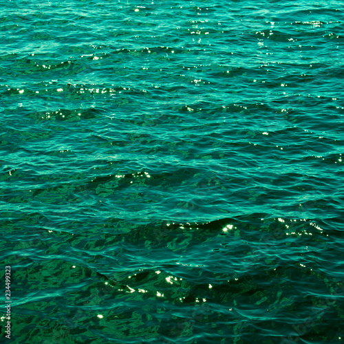 The emerald green water of the Baltic Sea glistens in the sun a few days after midsummer, near the Island of Nicklösa in the Åland Islands, Finland.