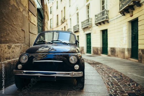 Black retro car parked on narrow italy street in Sardinia island © GVS
