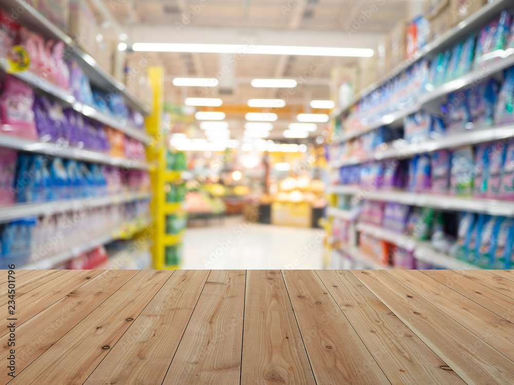 Empty wooden table and the Supermarket aisle abstract blur background. For present your products
