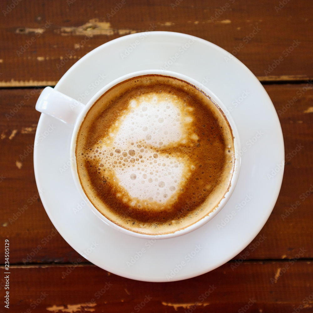 heart shape latte art in white coffee cup on wood table in cafe restaurant heart shape latte art in white coffee cup on wood table in cafe restaurant