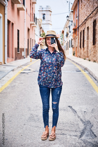 Beautiful young tourist with camera